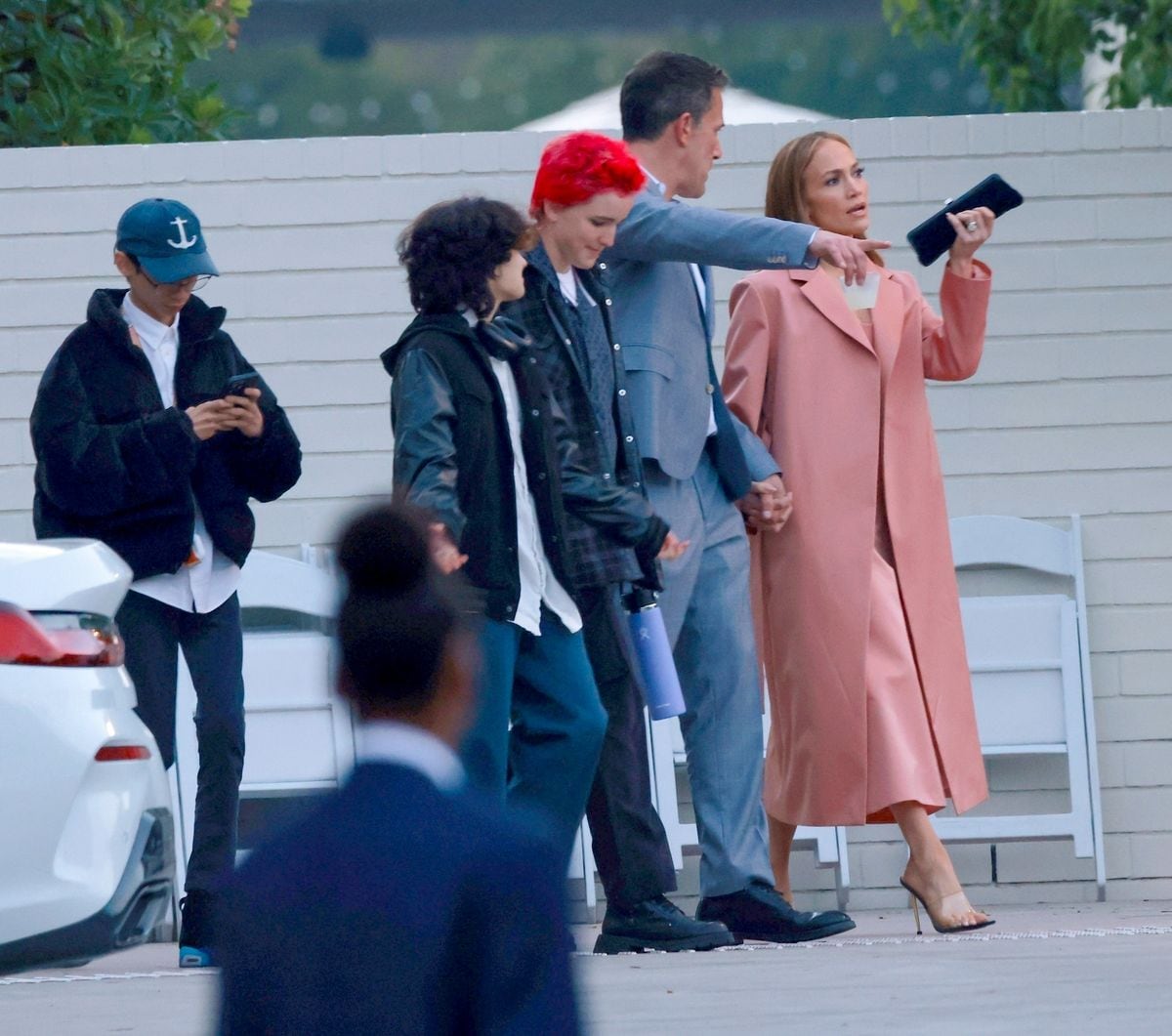 Ben Affleck and Jennifer Lopez briefly hold hands while leaving his daughter Violet's high school graduation ceremony.