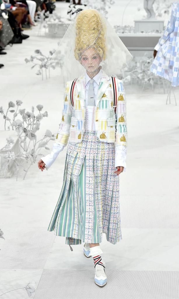 A model walks the catwalk in the Thom Browne fashion show wearing a patchwork outfit with multiple fabrics