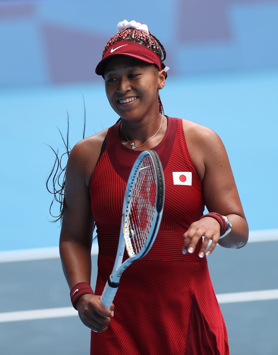 Naomi Osaka of Team Japan prepares to receive a serve during her Women's Singles Second Round match against Viktorija Golubic of Team Switzerland on day three of the Tokyo 2020 Olympic Games at Ariake Tennis Park on July 26, 2021, in Tokyo, Japan. 