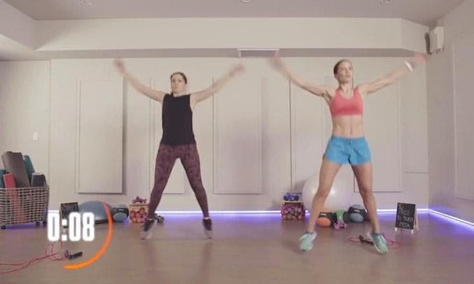 Alessandra Rosaldo and her personal trainer do some jumping jacks