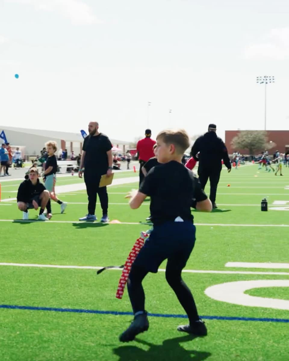 Eight-year-old Theo throws a perfect pass in the Flag Football championship, showcasing his impressive athletic abilities and game-winning skills.