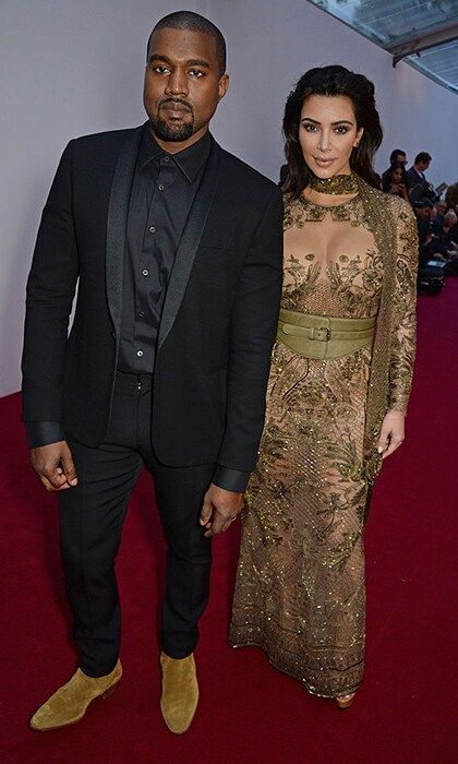 For British Vogue's Centenary gala dinner at Kensington Gardens in May 2016, Kim went for a see through green gown with a botanical motif, and Kanye wore a dark suit.
<br>
Photo: Getty Images