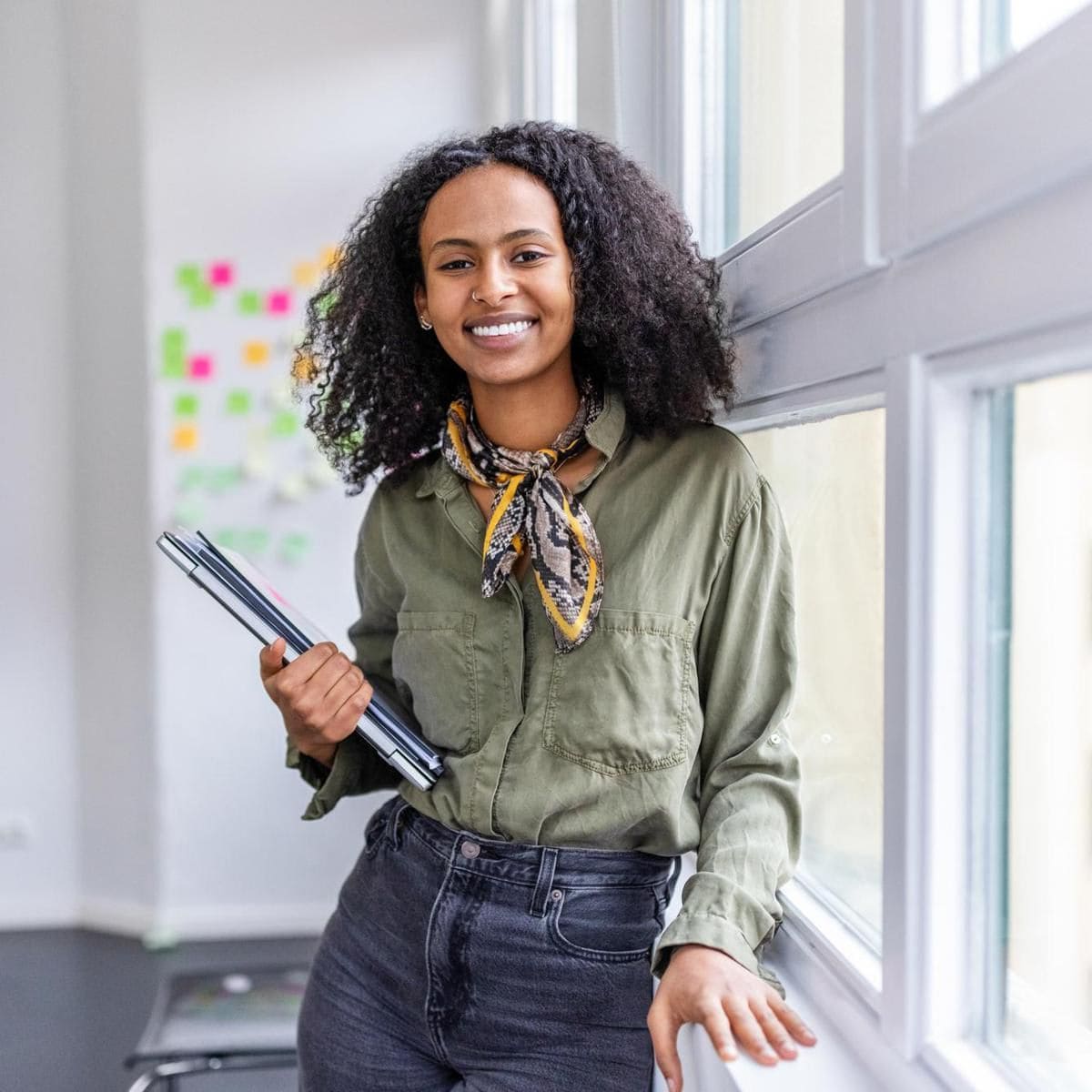 Smiling portrait of a beautiful woman standing in office