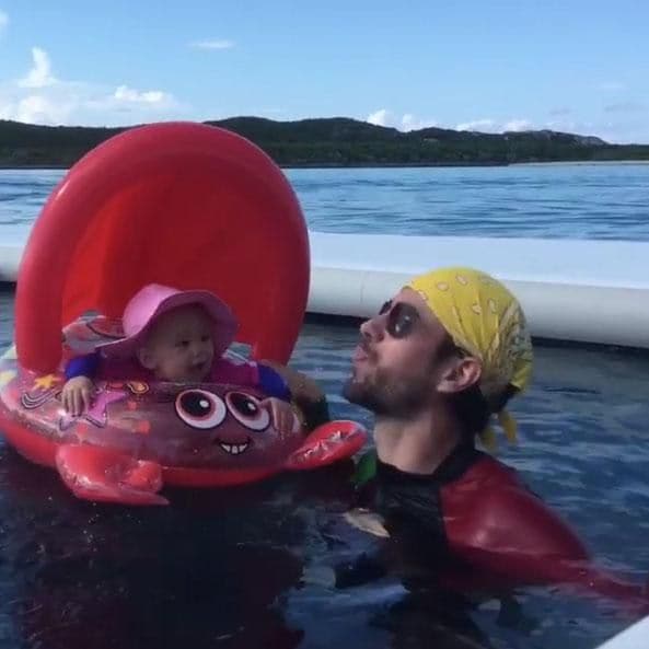 Enrique Iglesias plays in the water with one of his babies