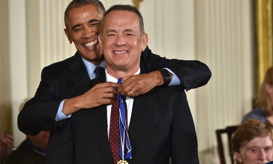 November 22: Tom Hanks smiled as he received his Presidential Medal of Freedom from President Obama at the White House.
Before presenting him with the honor, POTUS joked that no one in the room should travel with the actor in any circumstances saying,
"I mean, you think about it, you got pirates, plane crashes, you get marooned... (there's) volcanoes. Something happens with Tom Hanks... and yet somehow we can't resist going where he wants to take us."
Photo: NICHOLAS KAMM/AFP/Getty Images