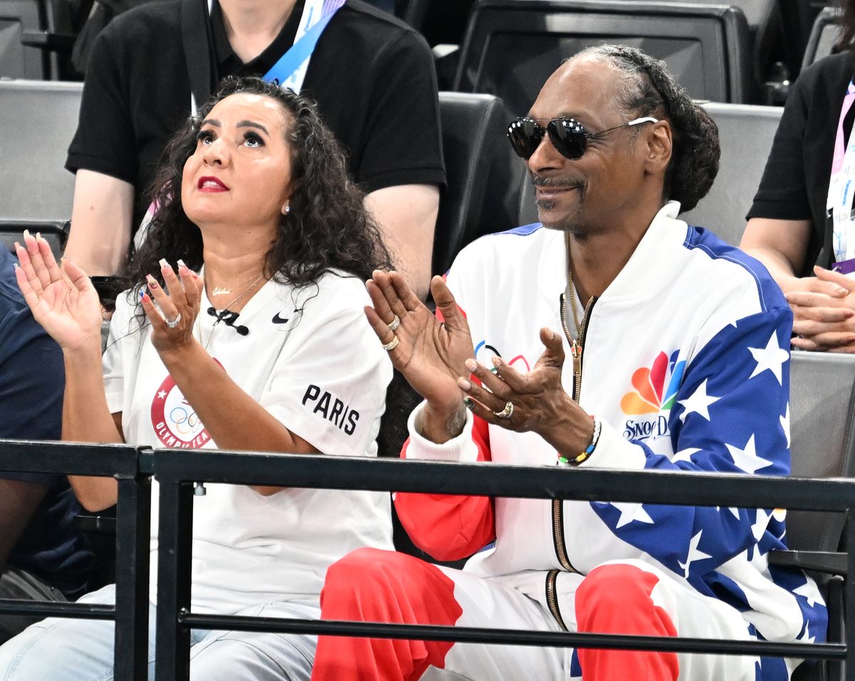 American rapper and record producer Snoop Dogg (R) applauds as he attends the Artistic Gymnastics Women's Qualification on day two of the Olympic Games Paris 2024 at Bercy Arena  in Paris, France on July 28, 2024. (Photo by Mustafa Yalcin/Anadolu via Getty Images)