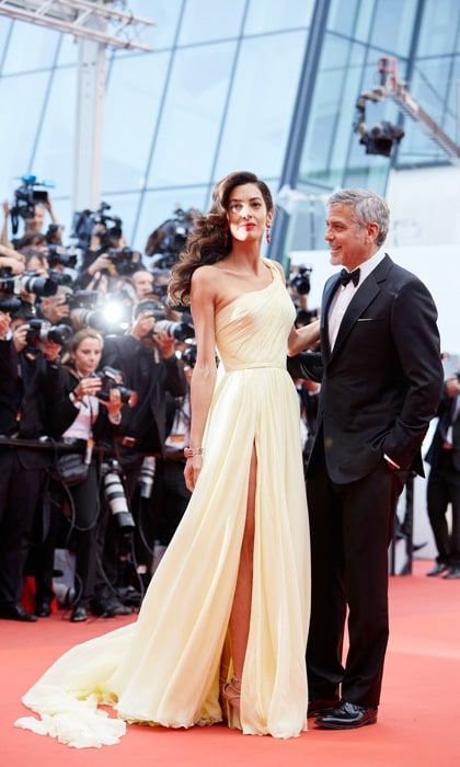 Behind these stunning leading ladies are adoring fans aka their husbands. With all eyes (and cameras) on them, these men weren't afraid to step aside to let their loves steal the spotlight and show their admiration in the process. Click through for a gallery of great photos of celebrity guys who are clearly in awe of their good fortune!
George Clooney couldn't help but smile as his wife Amal Clooney made her debut at the 2016 Cannes Film festival.
Photo: Kristina Nikishina/Epsilon/Getty Images