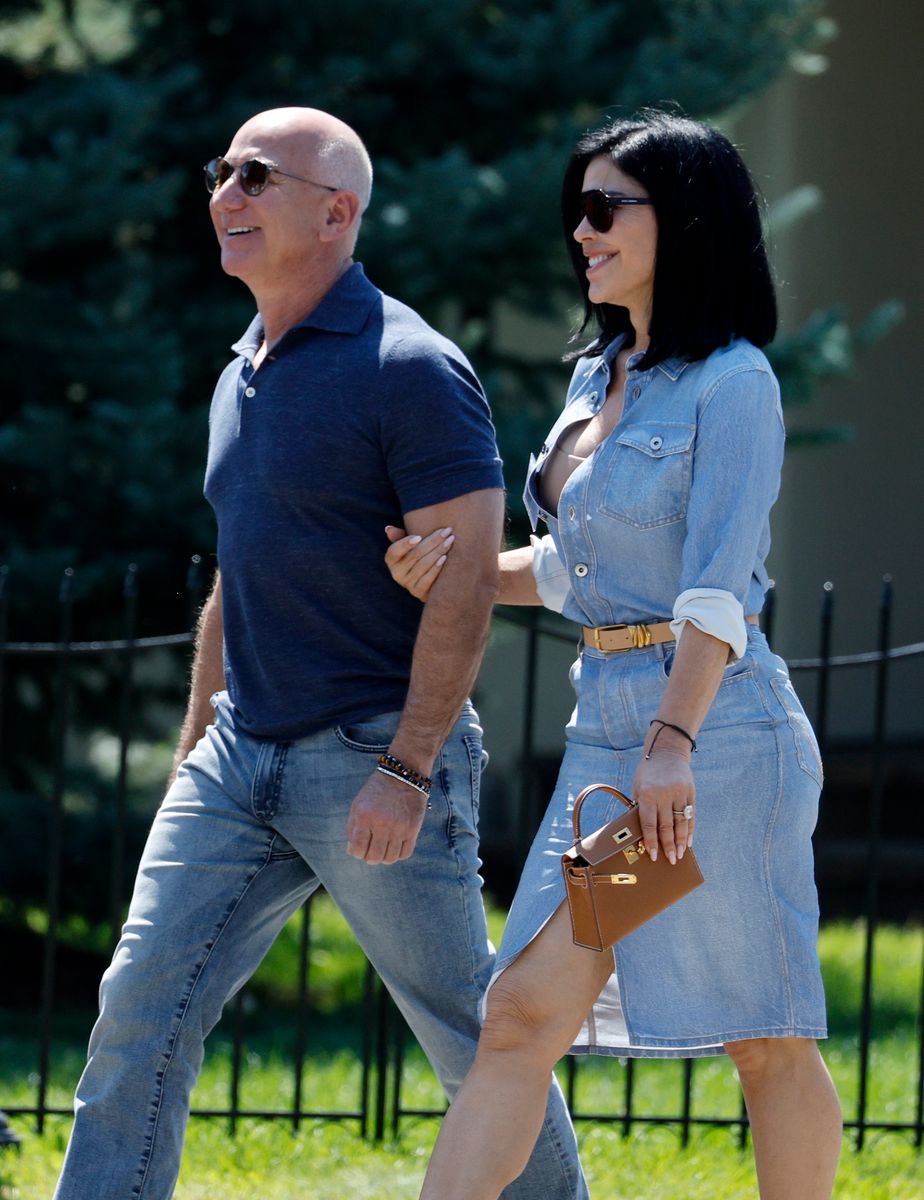 Jeff Bezos, founder of Amazon.com Inc., and Lauren Sanchez walk after the morning session during the Allen & Company Sun Valley Conference