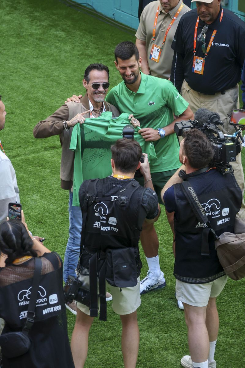 Marc Anthony took home one of Djokovic's signed jerseys, proudly showing off the item to the tournament's photographers