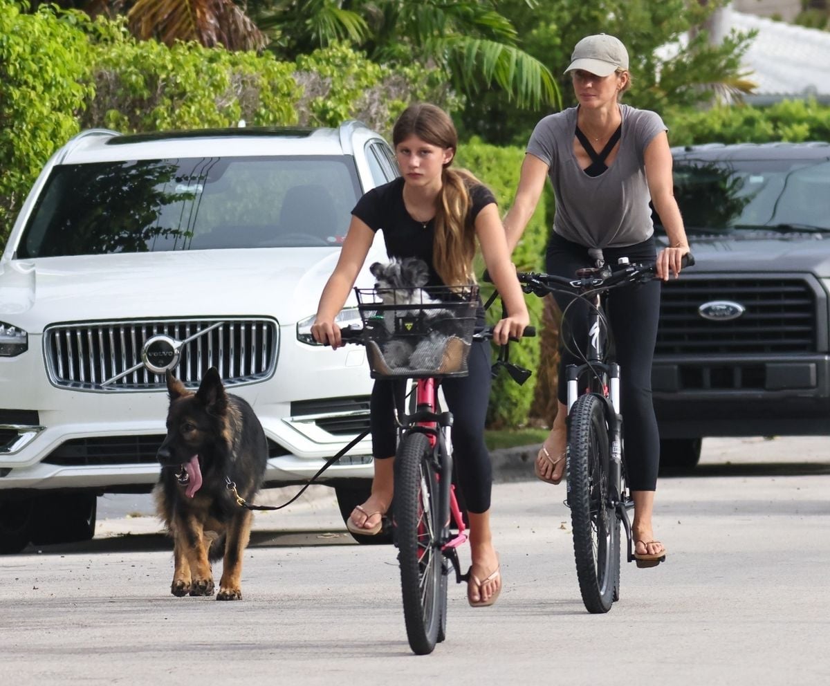 Gisele Bundchen goes for an early morning bike ride around the community with her daughter Vivian and their dogs after spending a short vacation and celebrating her birthday in Brazil surrounded by her entire family.