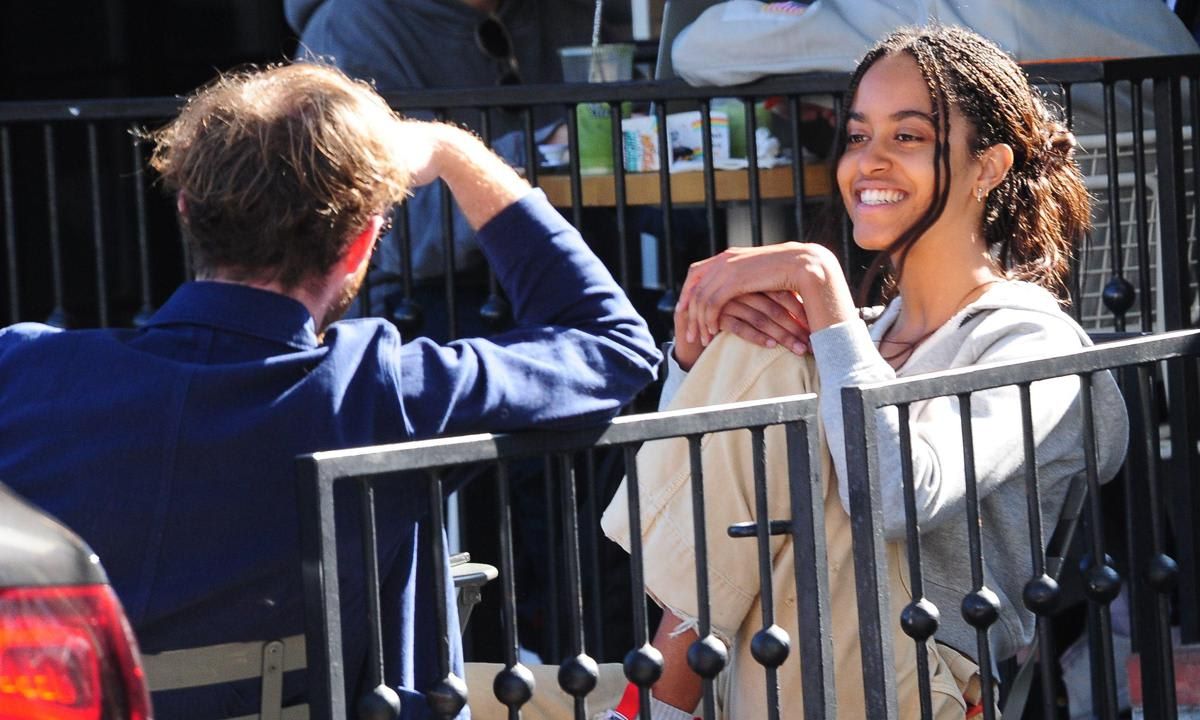 Malia Obama smiling getting coffee with friend