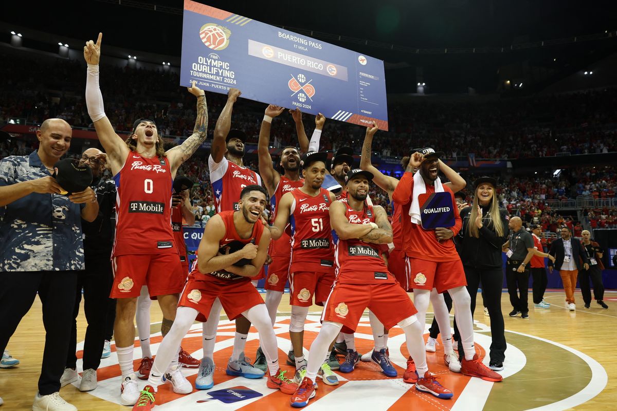 Puerto Rico's players celebrate with the ticket to the 2024 Paris Olympics after defeating Lithuania during the 2024 FIBA Men's Olympic Qualifying Tournament basketball match in San Juan, Puerto Rico, on July 7, 2024. 