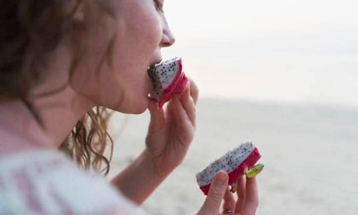 Woman eating dragon fruit