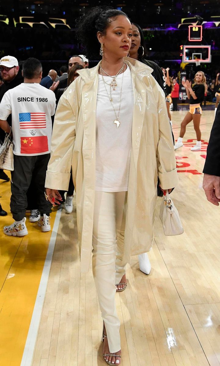 Rihanna in different white tones at a Lakers game