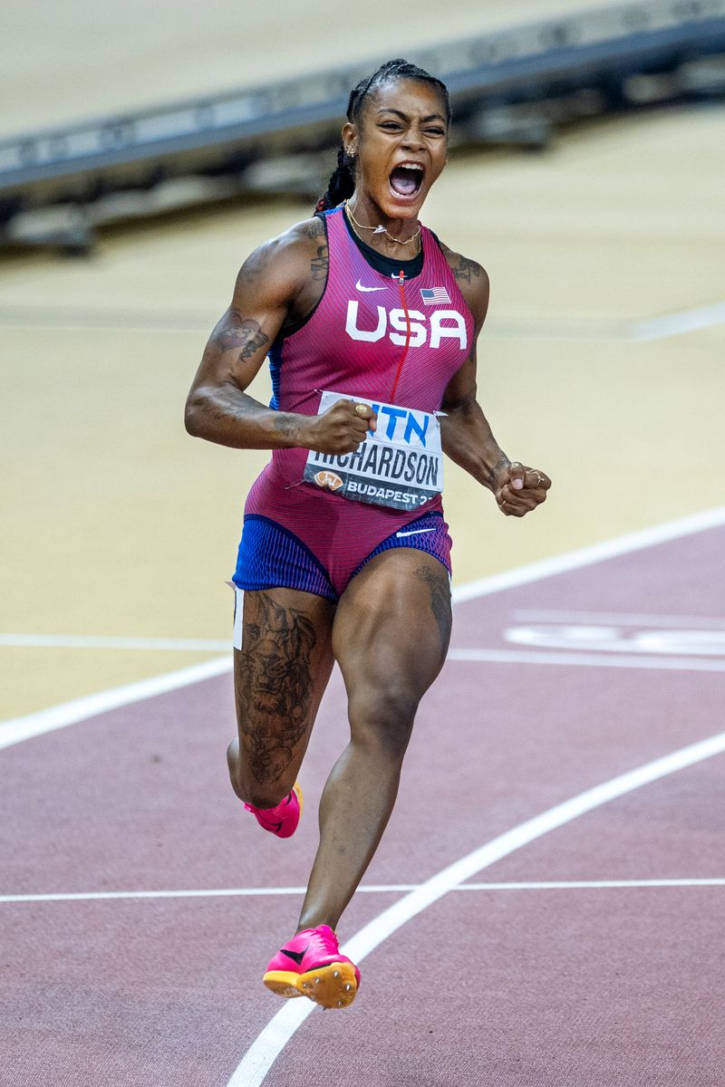 Sha'Carri Richardson of the United States celebrates as she crosses the line in lane nine to win the Women's 100m Final during the World Athletics Championships at the National Athletics Centre on August 21st, 2023, in Budapest, Hungary.