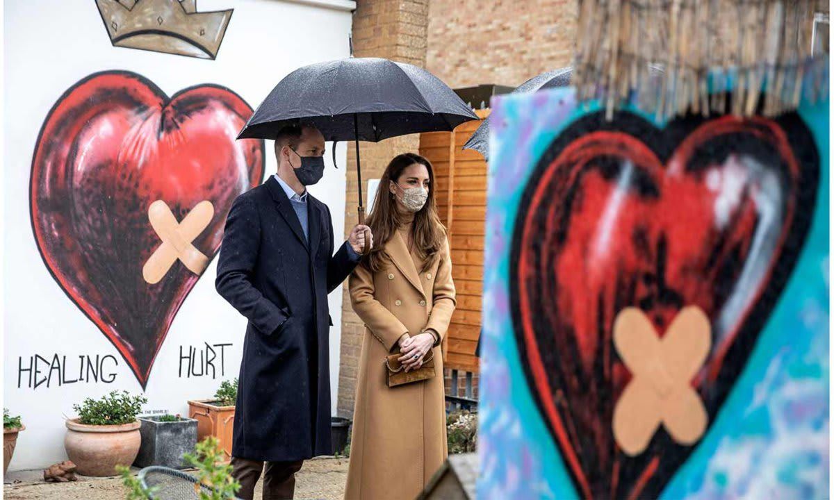 The parents of three stood in front of street art during a visit to the Newham Ambulance Station in March.
