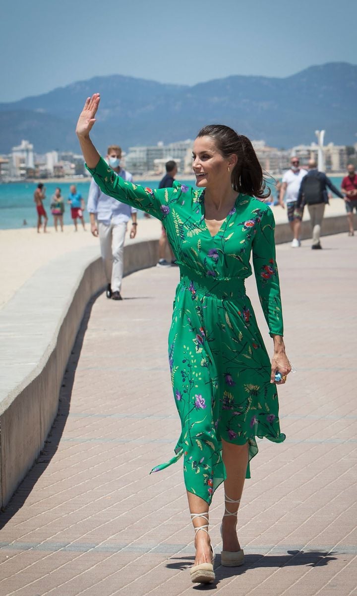 Princess Leonor's mom looked gorgeous in green sporting a floral print Maje dress, which she first wore in 2019, and Mint and Rose espadrilles for her visit to the Balearic Islands.