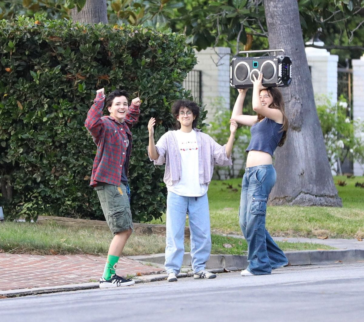 Fin, Emme, and a friend dance on the street in Brentwood. The two stayed friends despite parents divorce