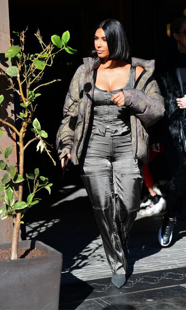 Kim Kardashian in a puffer coat, top, pants and pointed ankle boots