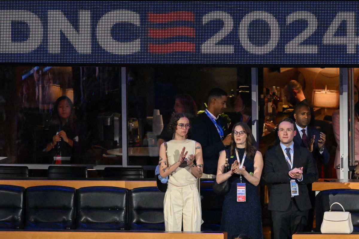 Ella Emhoff and Cole Emhoff applaud during the first day of the Democratic National Convention 