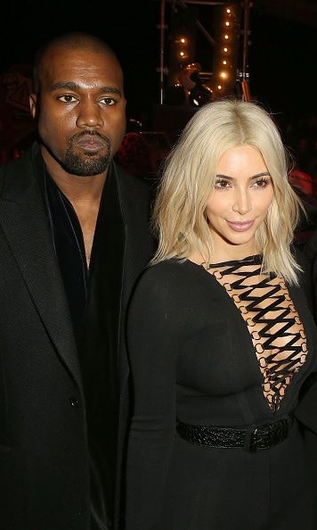 The two continued their Paris Fashion Week glamour tour coordinating their looks along the way. Kim belted her black body pantsuit contrasting her platinum blonde hair front row at the Givenchy show.
<br>Photo: Getty Images
