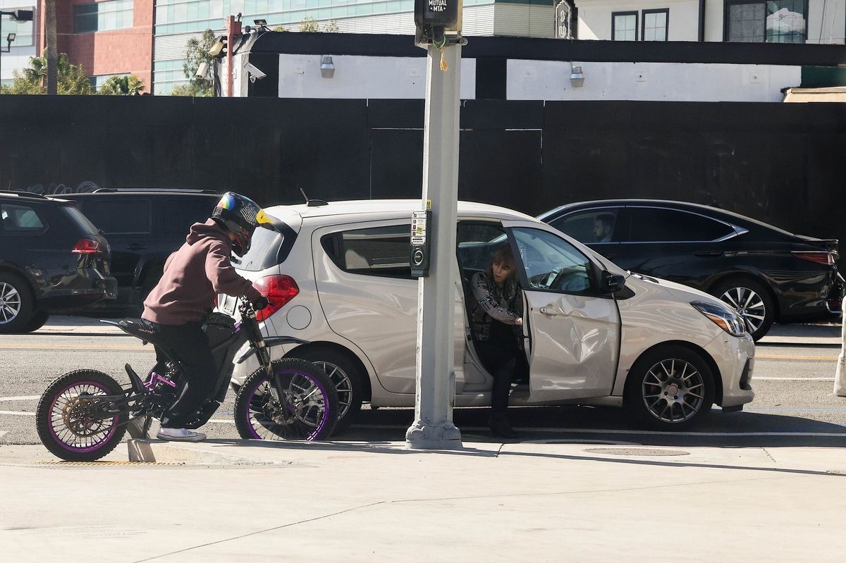 Pax Jolie-Pitt, son of Angelina Jolie, was seen riding his electric bike again, the same model and helmet he used before his serious accident last year. After showing off and doing some tricks, Pax gets involved in ANOTHER accident and dents a couple's Chevy!