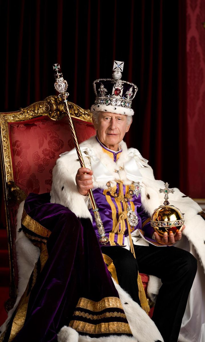 King Charles was pictured wearing the Robe of Estate and the Imperial State Crown, while holding the Sovereign's Orb and Sovereign's Sceptre with Cross in the Throne Room at Buckingham Palace.