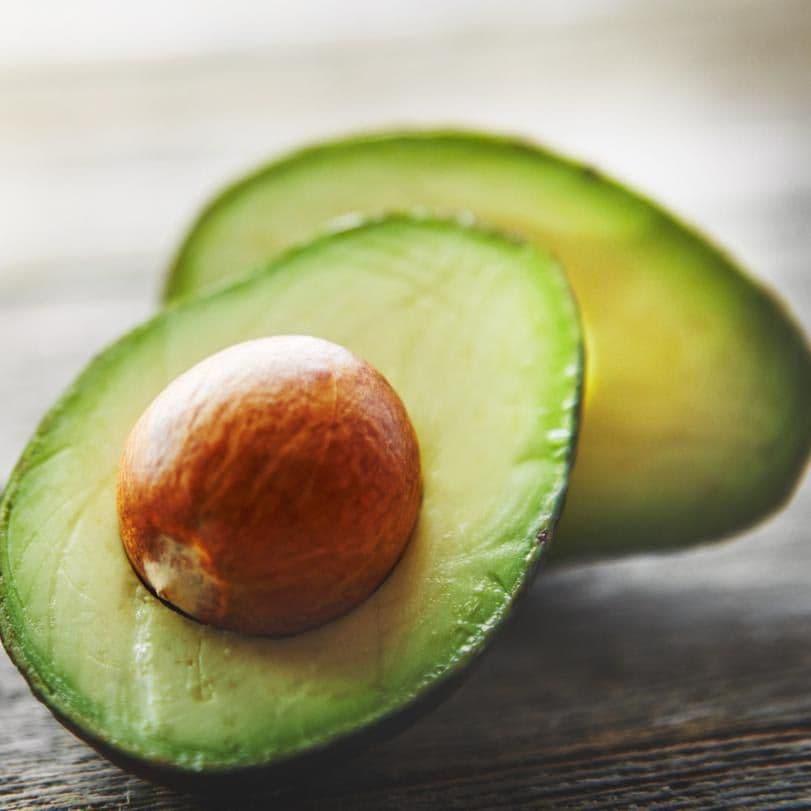 pieces of avocado on a wooden table