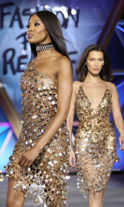 Bella Hadid and the hostess of the evening wore similar gold dresses down the catwalk. The 47-year-old icon hinted that she may be retiring from the runway as she addressed attendees that included Paris Hilton and Carla Bruni. "I don't know if I can walk much longer, it's been 32 years," she reportedly shared. "But it's an honor to walk. . . . I'd love for it to be carried on by the younger generation and for me to sit in the audience and watch."
Photo: Getty Images