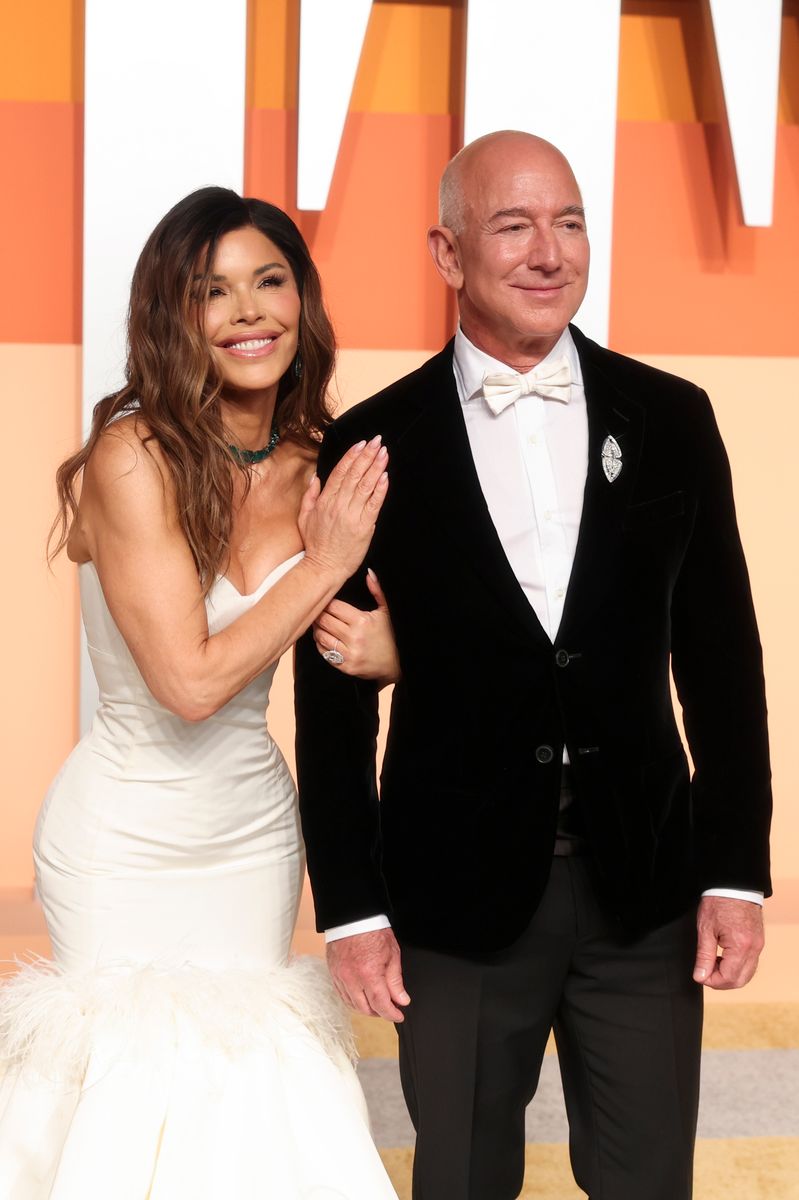 Lauren Sanchez wore a bridal gown at the Vanity Fair Oscars After Party. She was accompanied by her fiance Jeff Bezos