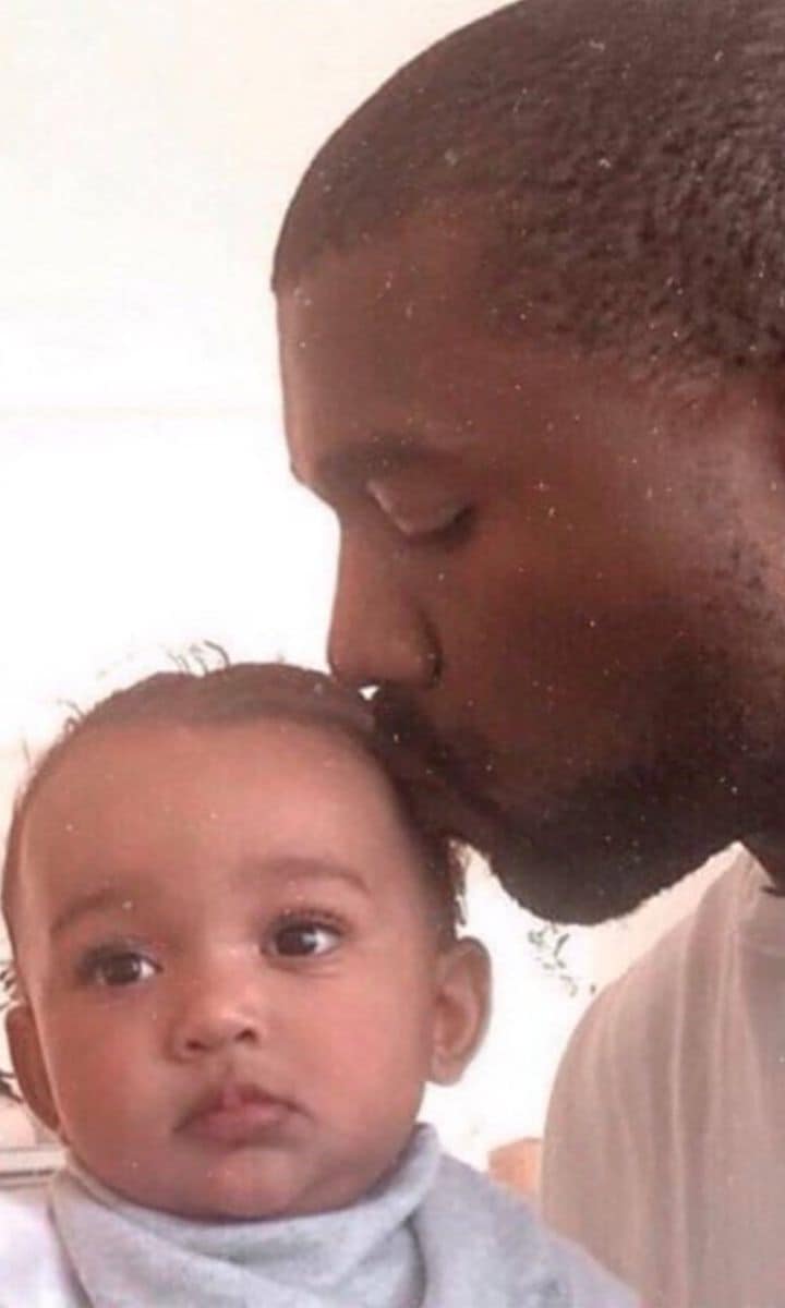 Kanye West giving Chicago West a kiss on the head.