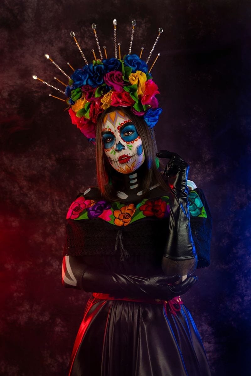 Portrait of a catrina with a crown of flowers on the Day of the Dead to celebrate her ancestors.