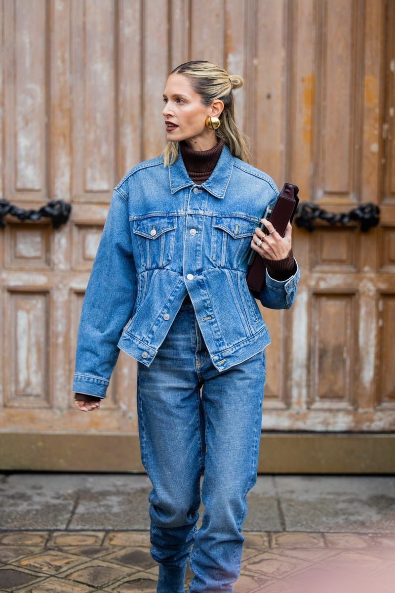 Helena Bordon wears burgundy bag, denim jacket, jeans, brown turtleneck, golden earrings outside Hermes during the Womenswear Fall/Winter 2024/2025 as part of  Paris Fashion Week on March 02, 2024 in Paris, France. (Photo by Christian Vierig/Getty Images)