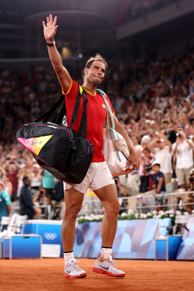 Rafael Nadal of Team Spain acknowledges the crowd as he leaves the court with a partner (out of frame) Carlos Alcaraz of Team Spain after their Men's Doubles Quarter-final match against Austin Krajicek of Team United States and Rajeev Ram of Team United States on day five of the Olympic Games Paris 2024 at Roland Garros on July 31, 2024, in Paris, France. (Photo by Julian Finney/Getty Images)