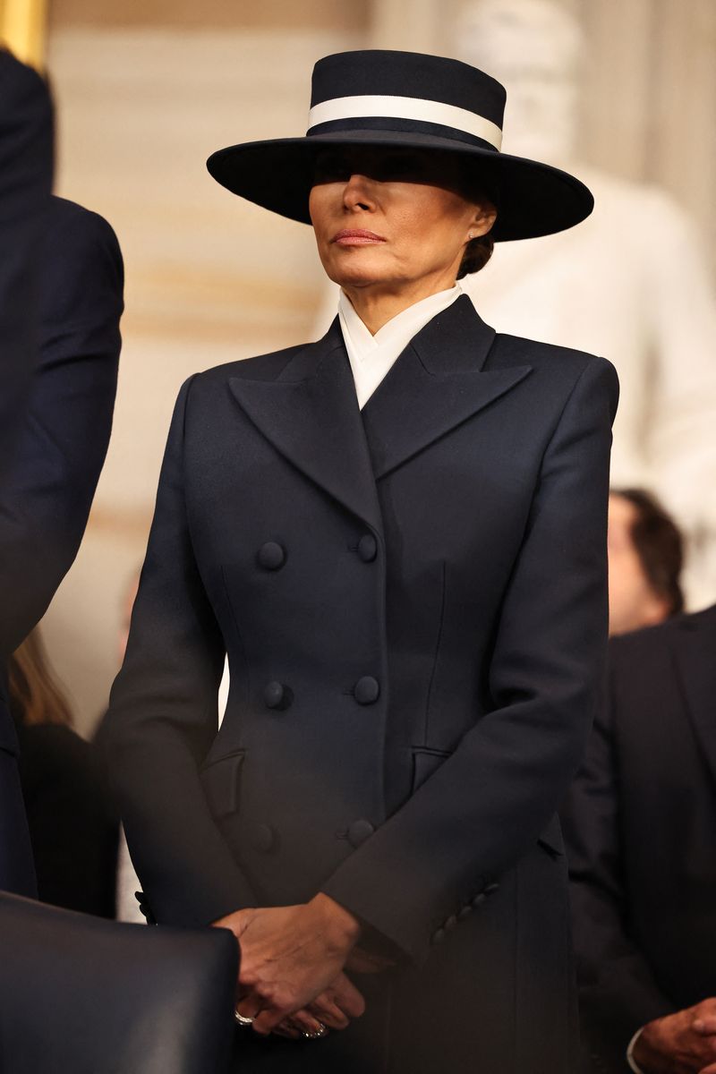 Melania Trump bows her head in prayer during inauguration ceremonies in the Rotunda of the US Capitol 