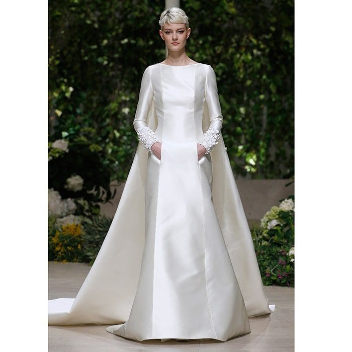 A modest yet modern structured satin look shown on the Pronovias catwalk comes complete with cape and pockets.
Photo: Getty Images