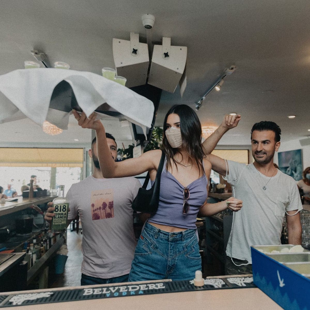 Kendall Jenner is officially a bartender! The businesswoman served her 818 Tequila to fans while visiting the Hamptons