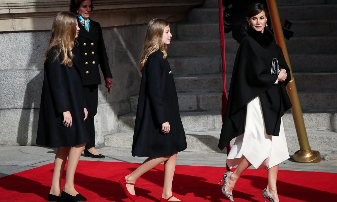 Queen Letizia and her daughters were twinning in black outwear. While the Spanish Princesses wore coats, their ever-stylish mother kept warm in a Carolina Herrera cape that featured a fur collar.