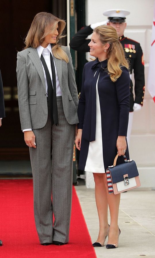 Melania swapped her usual ultra-feminine body-hugging oufits for a pinstriped business suit with loose tie as she greeted Canada's First Lady Sophie Gregoire Trudeau at the White House on October 11. The look which fits right in with fall's masculine trend is by Ralph Lauren Collection.
Photo: Getty Images