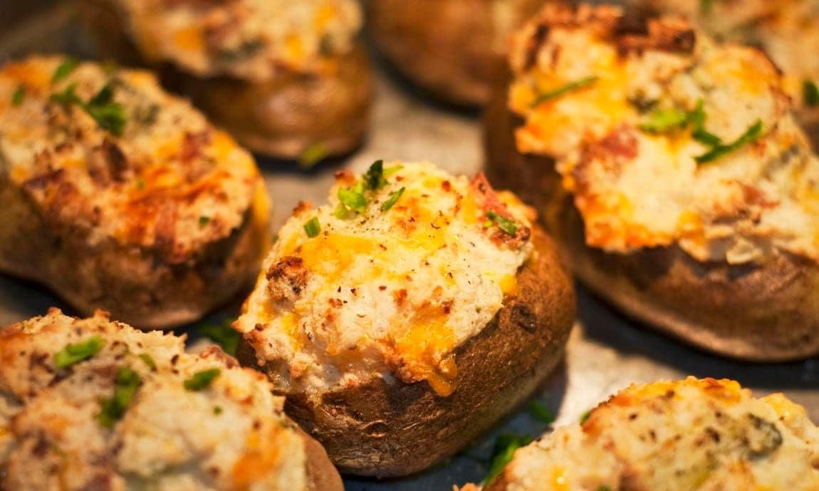 Baked potatoes with melted cheese on top