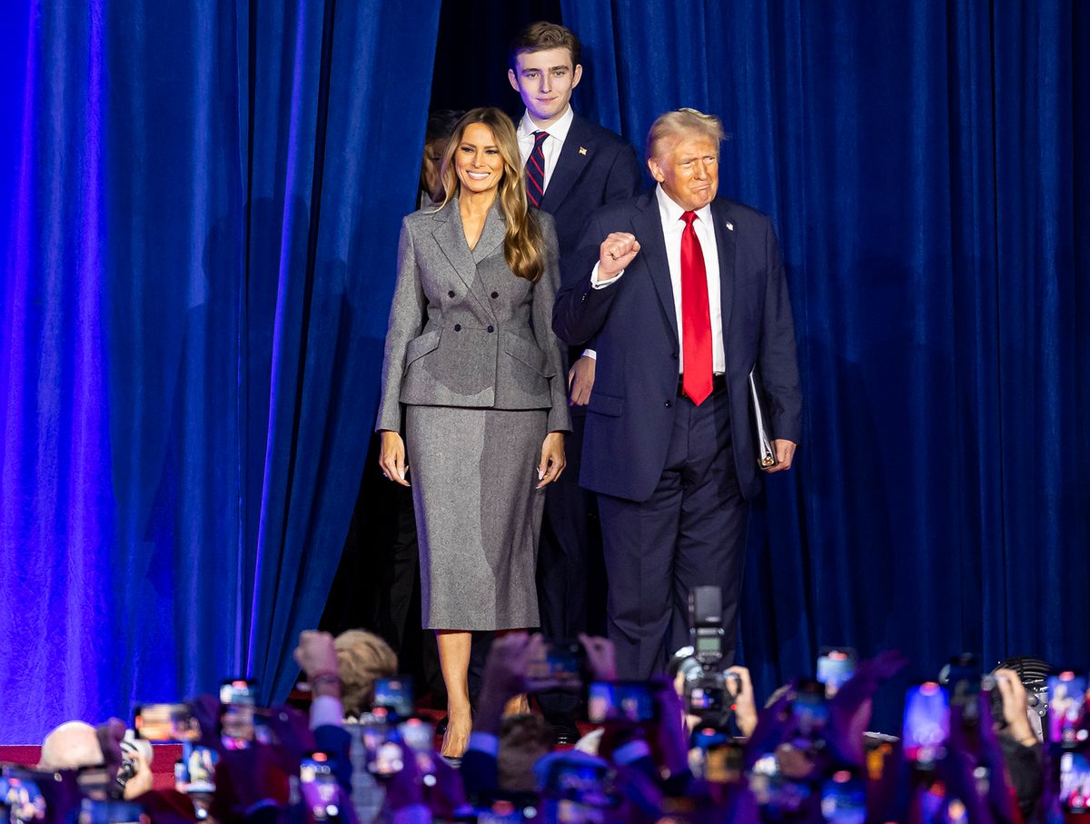 President Donald Trump arrives to his election night party alongside his wife, Melania Trump, and his son, Barron Trump, at the Palm Beach County Convention Center 