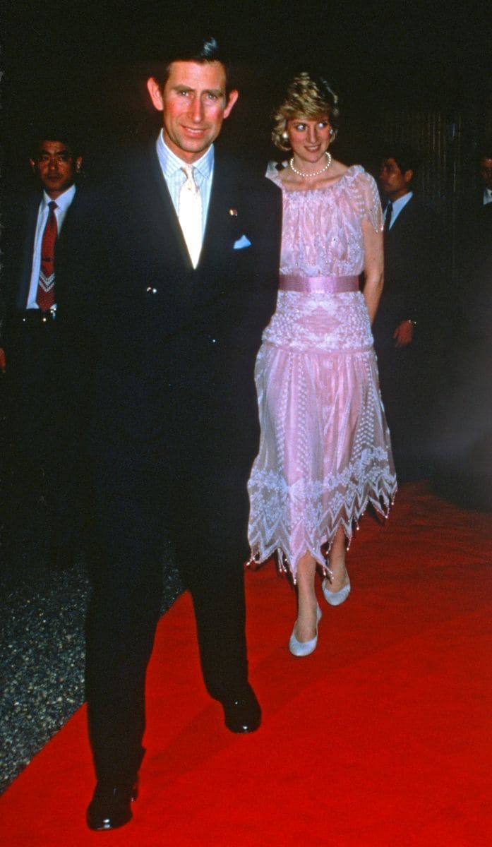 Princess Diana wears a pink chiffon dress, decorated with rhinestones, crystal beads, and pearl droplets designed by Zandra Rhodes.