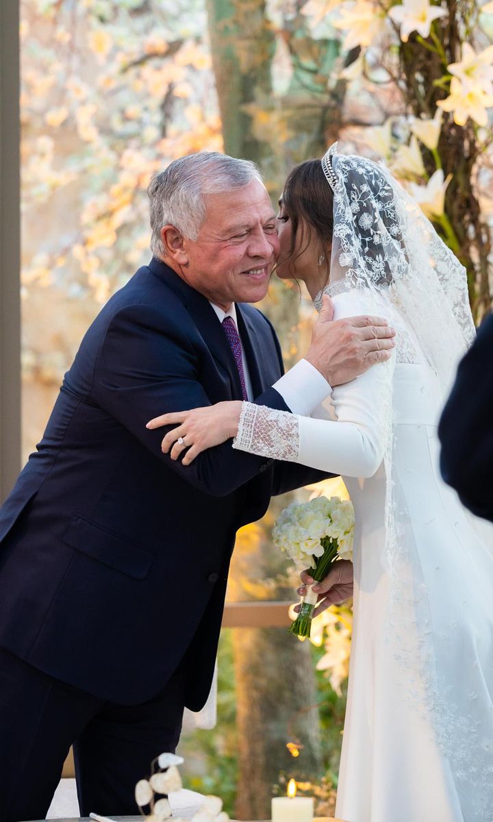 The Princess gave her father a kiss before and after the ceremony.