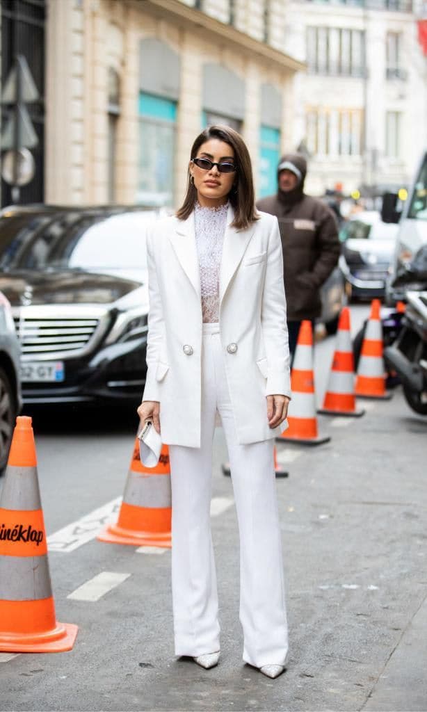 Camila Coelho with white two-piece suit