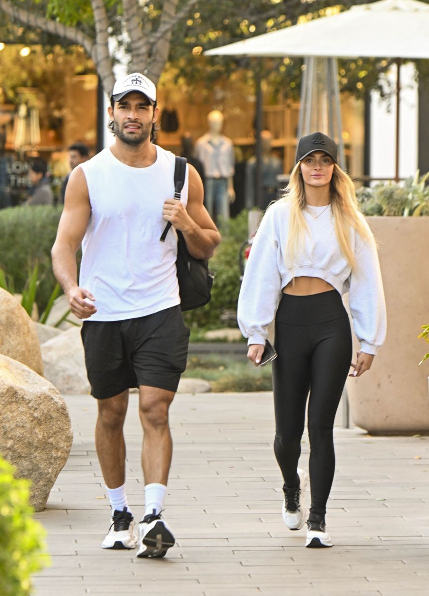 American model and actor Sam Asghari and his girlfriend Brooke Irvine left the gym smiling in Studio City, Los Angeles. The couple held hands while sporting matching black and white sports outfits, exuding happiness and style.
