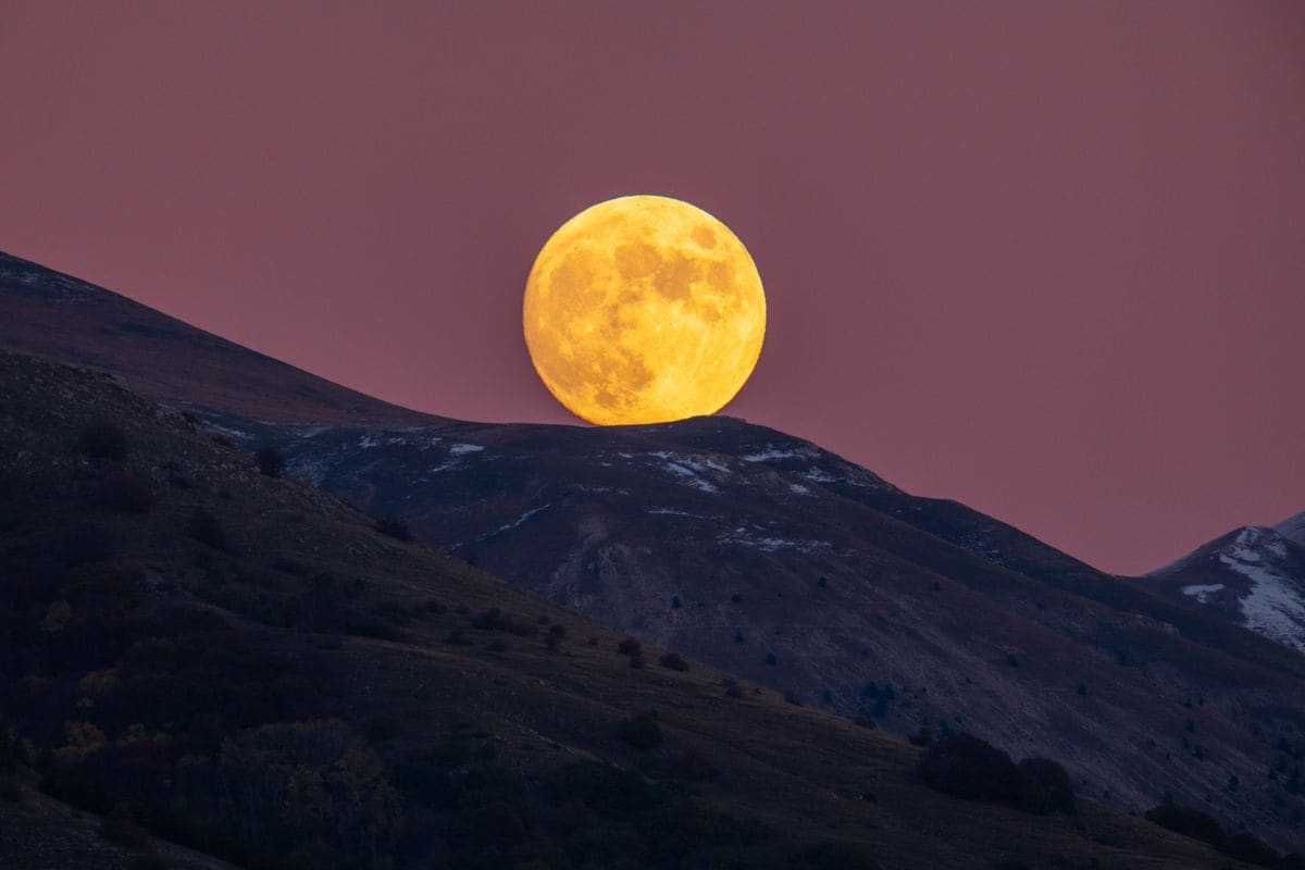 Beaver moon rising behind Gran Sasso d'Italia 