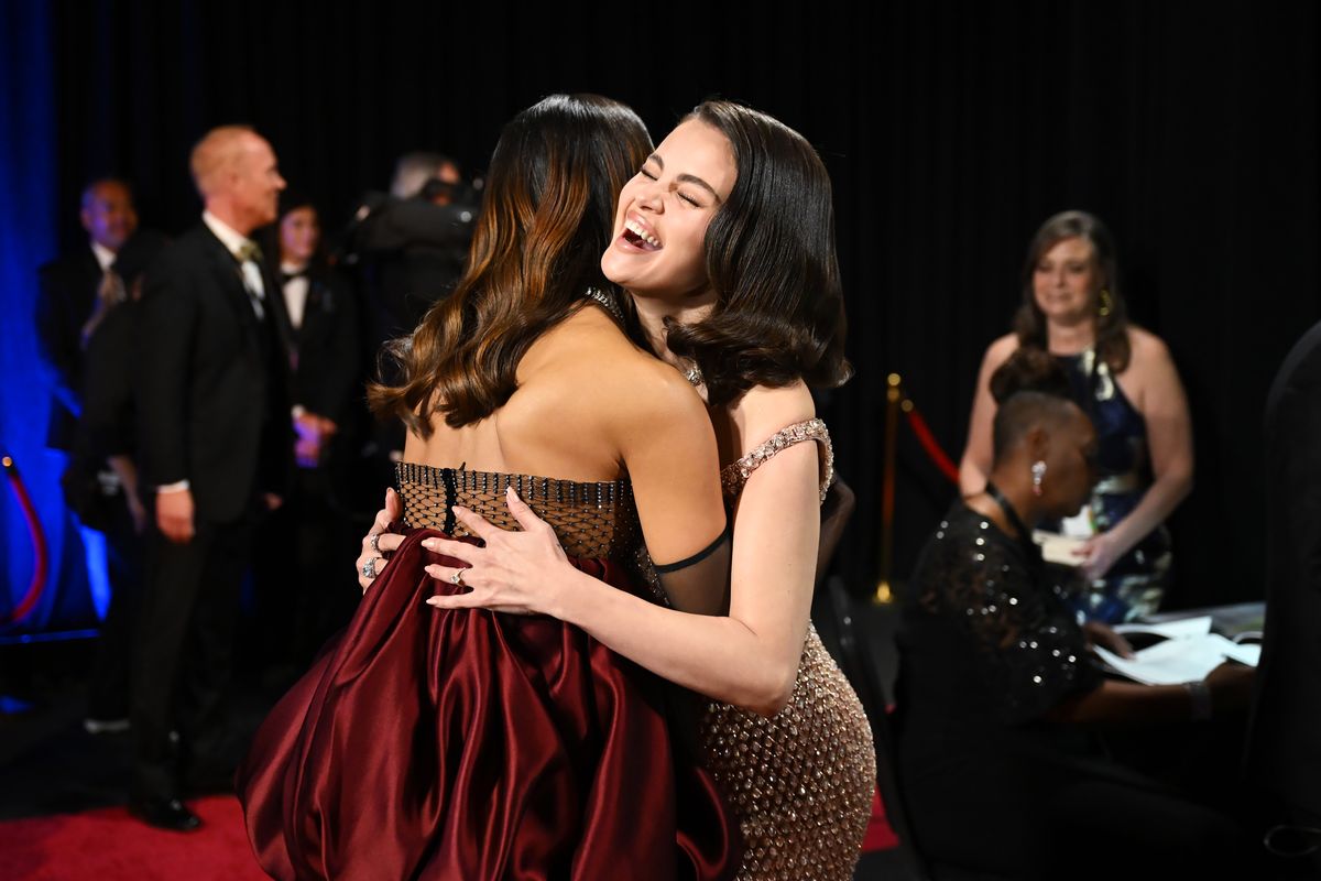 Zoe Saldaña seen hugging Selena Gomez backstage hugging after she won Best Supporting Actress for her role in Emilia Perez. 