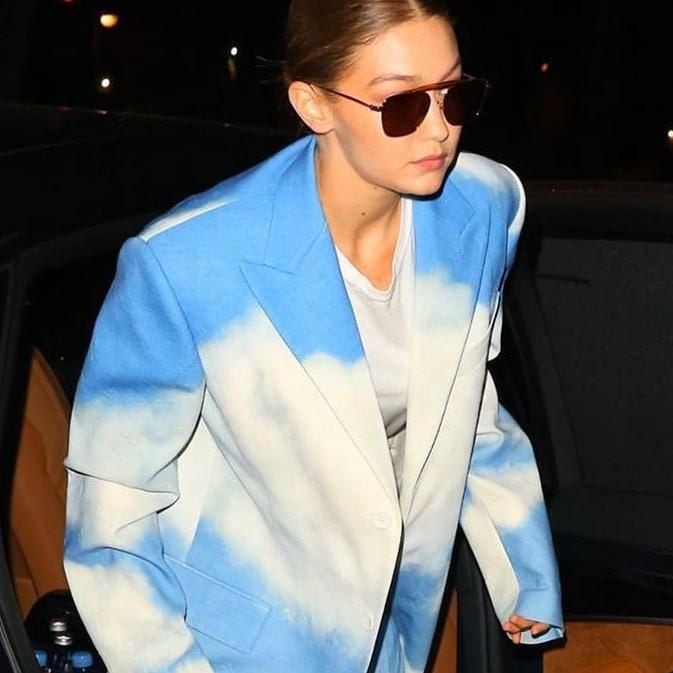 Gigi Hadid with sunglasses and a tie dye outfit