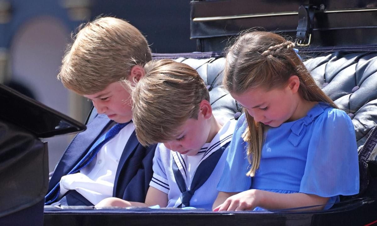 The Cambridge kids were pictured bowing their heads while in the carriage.