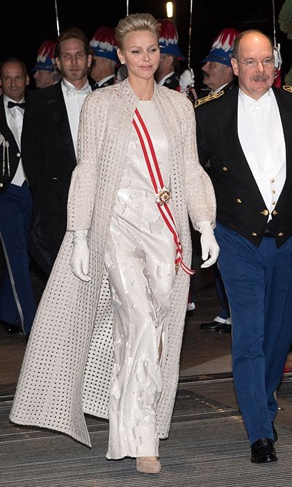 In the evening, Princess Charlene swapped her royal blue velvet for a sweeping, perforated coat by Akris worn over a gown by the brand. The royal finished off the look with white gloves and suede shoes in a natural hue.
Photo: Getty Images